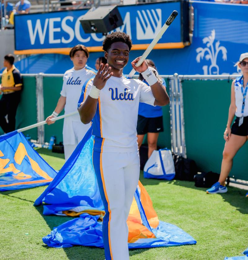 Cheer Squad member holding a flag at the Rose Bowl