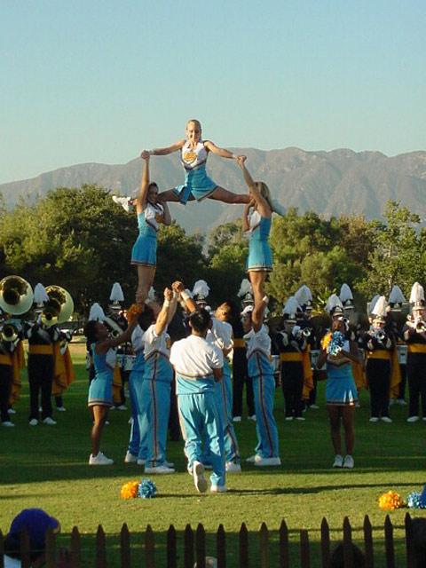 the 2002 Squad performing before a football game